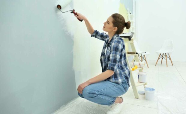 Woman painting her walls with Benjamin Moore paint