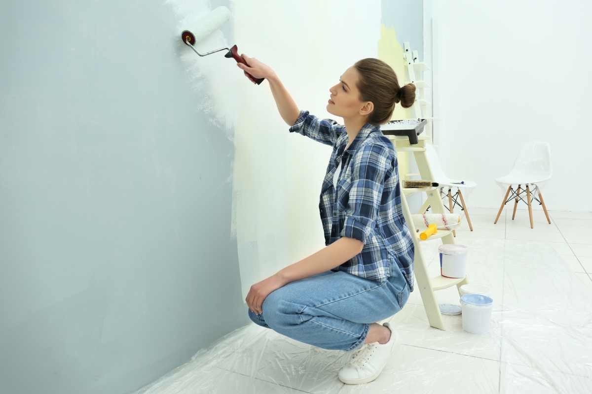 Woman painting her walls with Benjamin Moore paint
